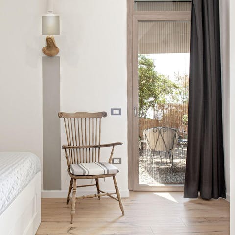 Open up the bedroom’s French door and let the sea air in