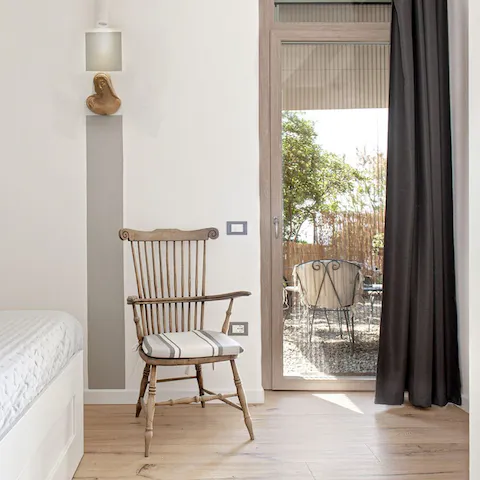 Open up the bedroom’s French door and let the sea air in