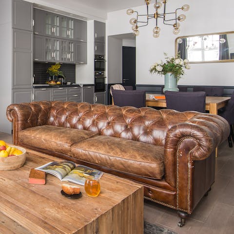 Relax on the large Chesterfield sofa after a day on your feet