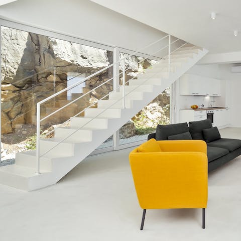 The natural cliff face can be seen in the glass wall by the stairs