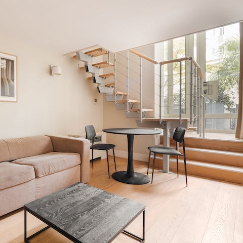 Relax in the light-filled living area after a busy day of Paris exploring