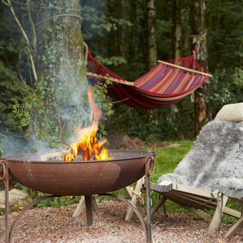 Stretch out beside the fire pit in the hammock