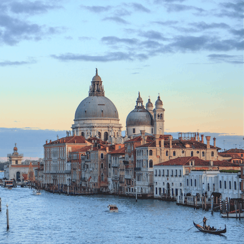 Hire a gondola to explore Venice via its many canals and waterways