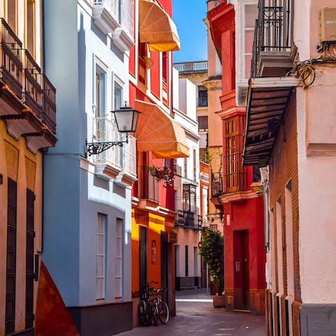 Lose yourself in tiny streets of Seville's Barrio Santa Cruz, within a two-hour drive