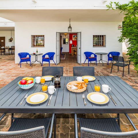 Sit down to enjoy an alfresco breakfast of pastries and café con leche