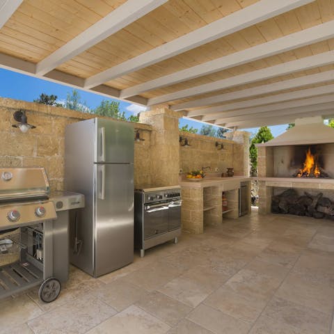 Feed the troops while enjoying the heat with the large outdoor kitchen