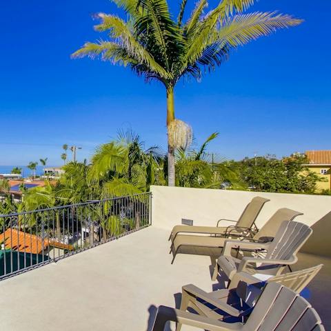 Sunbathe with iconic palm tree views