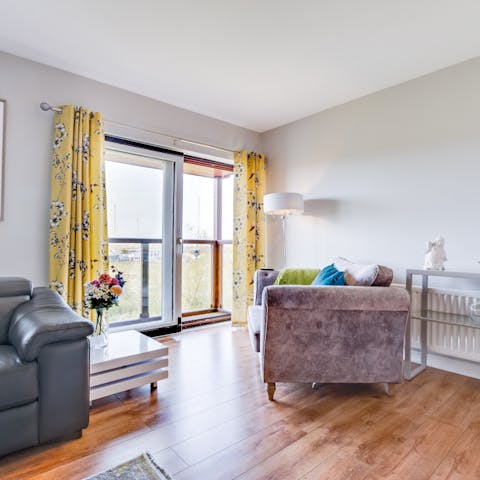 Curl up on the velvet armchair in front of the glass doors in the living room