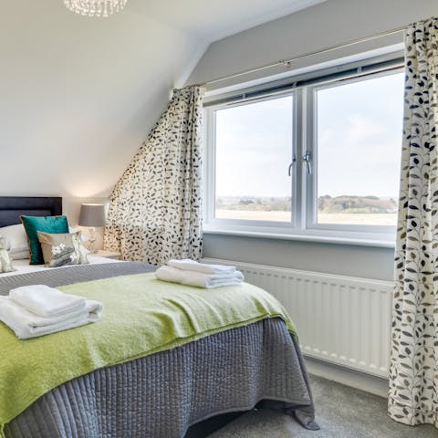 Gaze out the window at fields and sea from the main bedroom