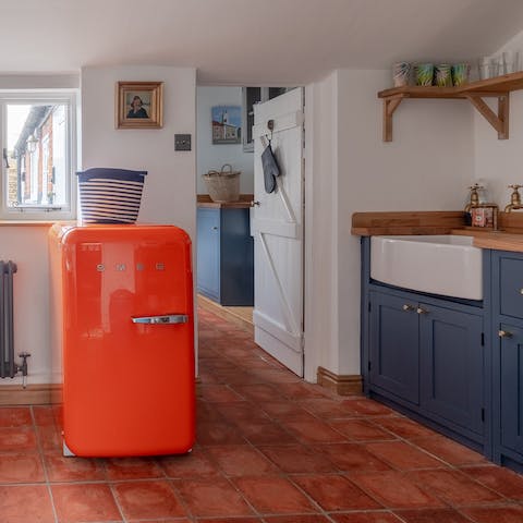 Make the most of cooking in the retro kitchen with its orange Smeg fridge