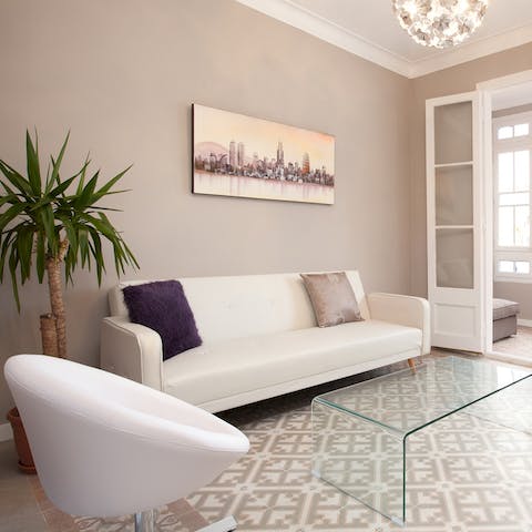 Relax in the stylish living area with a glass of Spanish wine after a day of touring the city