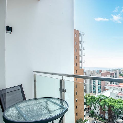 Sip your morning coffee on the private balcony, drinking in the city views