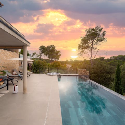 Watch glorious sunsets over the sea from the private heated infinity pool