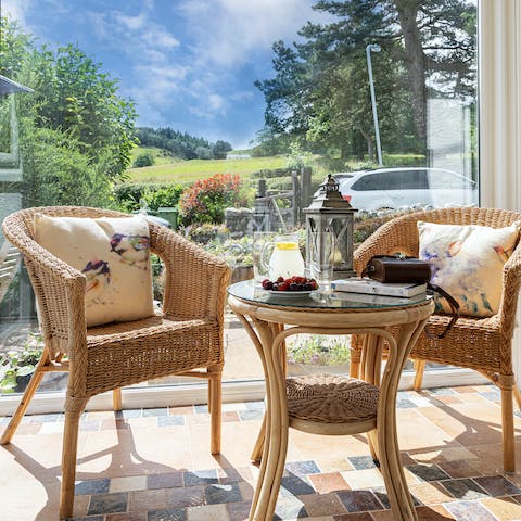 Take a seat in the sun room and watch birds at the feeders in the garden