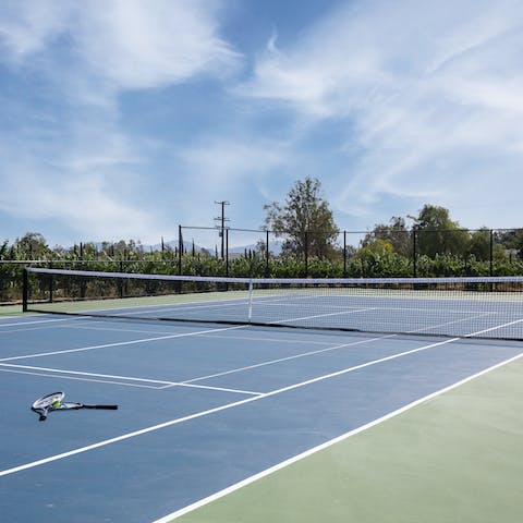 Pack your racquet and have a game of tennis on the home's court
