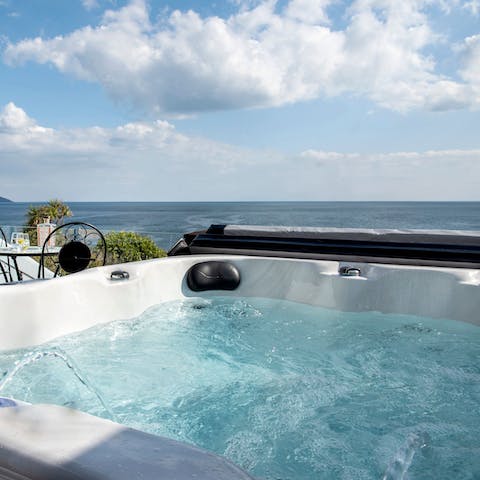 Sink into the hot tub for a long soak with a sea view
