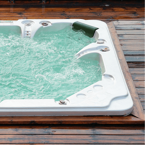 Sip a glass of whiskey as you unwind in the private hot tub