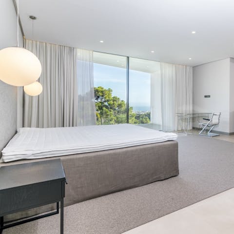 Pad out onto the balcony of the light-filled bedroom and soak up the sea views