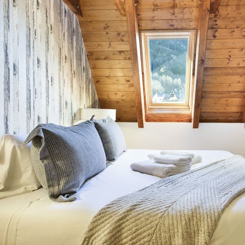 Sink into the comfy beds after a long day and drift off underneath the timber-clad A-frame ceilings