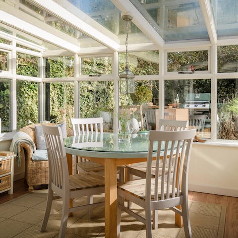Start your day in the bright conservatory overlooking the lush garden