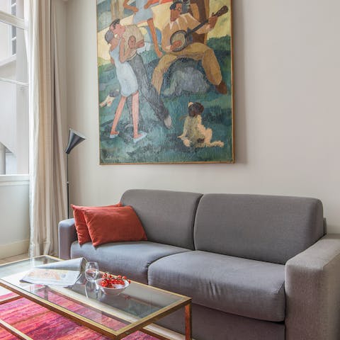 Appreciate the statement artwork and the bold furnishings in this elegant Paris apartment