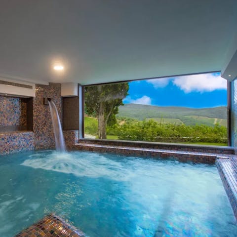 Luxuriate in the heated indoor pool with panoramic countryside views