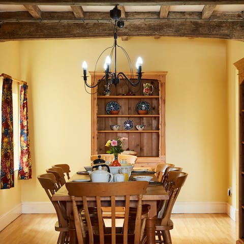 Gather around the kitchen table for relaxed dinners and drinks at home beneath the warm-toned chandelier