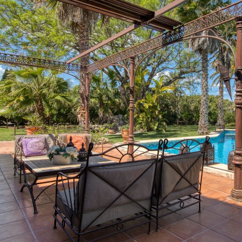 Sip cocktails on the wrought-iron patio furniture