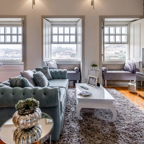 Kick back on the elegant sofa with a glass of wine while enjoying views over Porto and the Douro River from the living room's windows