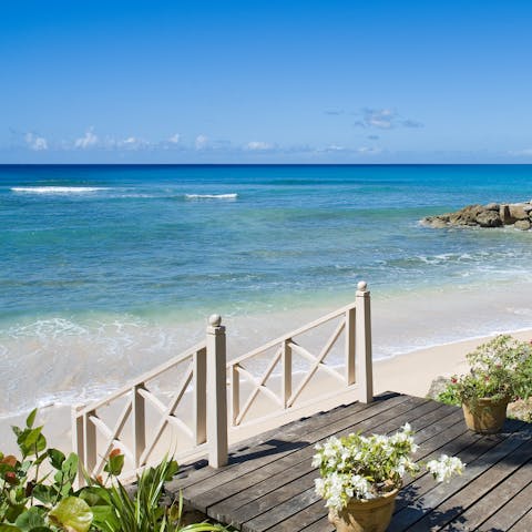 Step down onto the soft sand of Reeds Bay straight from the complex's garden