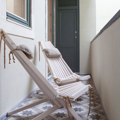 Enjoy a glass of Portuguese wine on the balcony