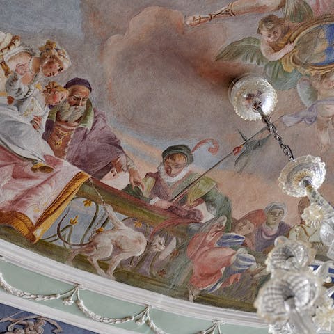 Admire the original sixteenth-century frescos on the ceilings