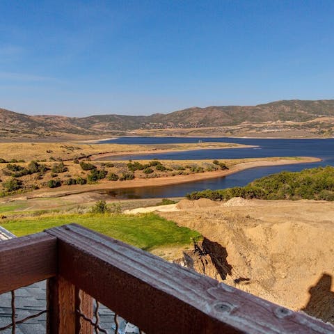 Look over the mountains and reservoir from the home's balconies