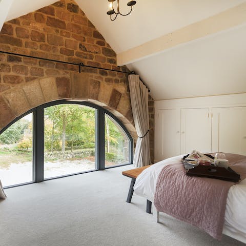 Wake up to stunning Peak District views from the master bedroom's arched window