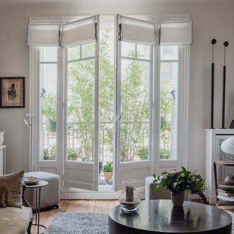 Open the French doors onto the Juliet balcony with its bamboo plants