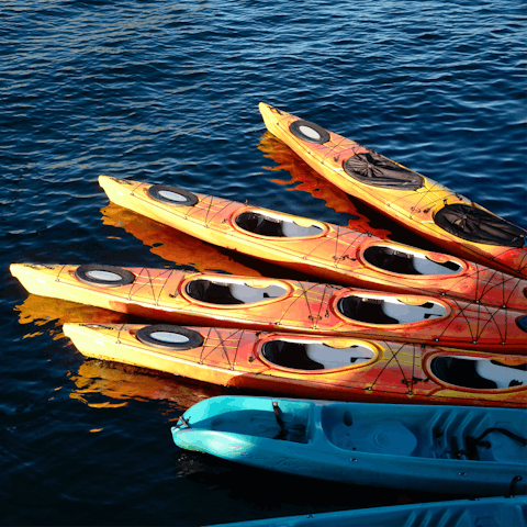 Hire kayaks or paddleboards for a day of watersports on the lake 