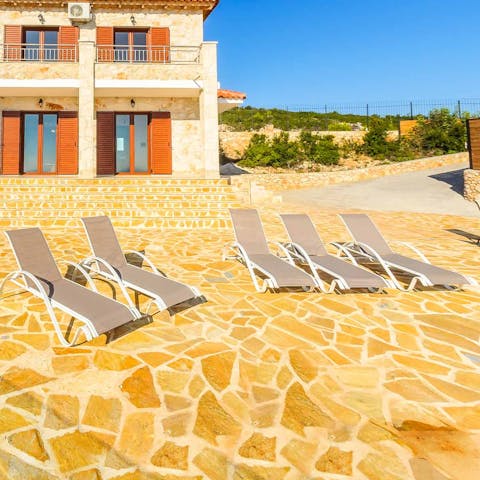 Soak up the Greek sunshine from the recliner loungers 