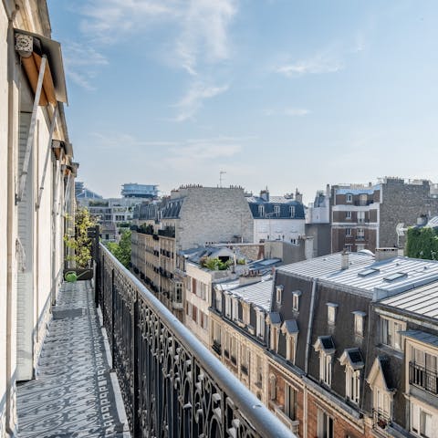 Take in the views over the Parisian rooftops from the private balcony