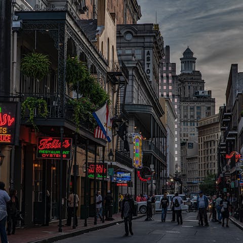 Experience a typical NOLA night on Bourbon Street, less than a ten-minute cab ride away