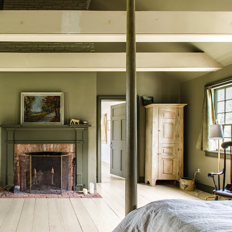 Feel at ease among the calming green tones of the master bedroom