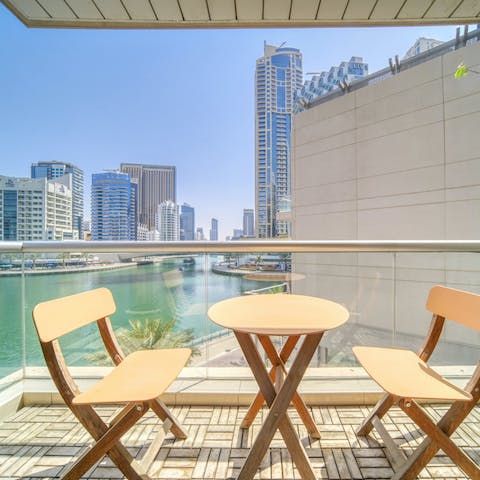 Look over Dubai Marina from the sun-soaked balcony
