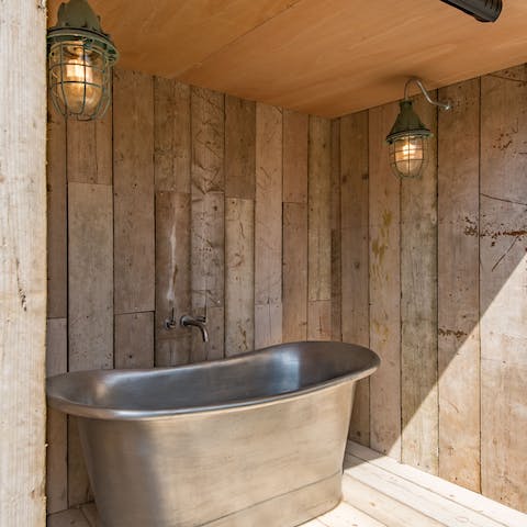 Enjoy an alfresco soak in the covered outdoor bathtub