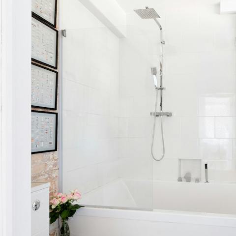 Enjoy a luxurious soak under the rainfall shower after a day of sightseeing
