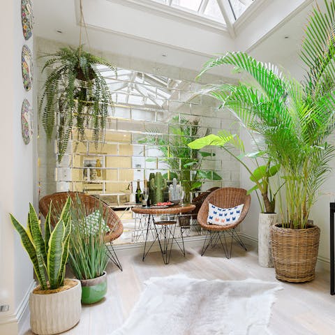 Relax amidst the plants in the jungle-like conservatory