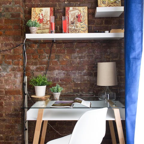 Get some work done at the desk, tucked against the exposed brick walls