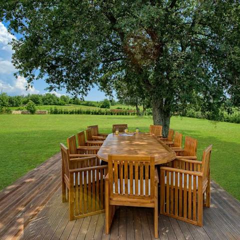 Dine beneath the olive tree on the lawn