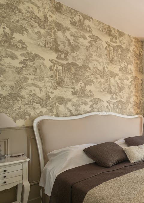 Admire the traditional touches, such as the Toile de Jouy in the bedroom