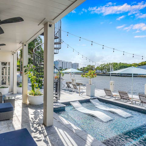 Admire waterfront views from the terrace or the pool's tanning shelf