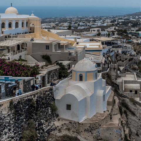 Stroll the winding streets and alleyways of picturesque Fira, within walking distance of the villa