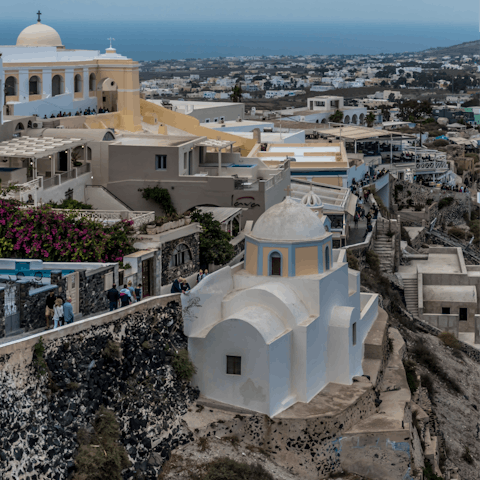 Stroll the winding streets and alleyways of picturesque Fira, within walking distance of the villa